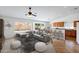 Open-concept living room featuring stylish furniture, adjacent dining area, and lots of natural light at 1669 E Santa Fiore St, San Tan Valley, AZ 85140
