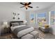 Cozy bedroom with natural light, carpet flooring, modern ceiling fan, and decorative area rug at 1669 E Santa Fiore St, San Tan Valley, AZ 85140