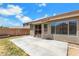 Spacious patio area with sliding glass door access to home's interior and large windows at 1669 E Santa Fiore St, San Tan Valley, AZ 85140