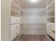 Organized walk-in closet with shelving and drawers for ample storage at 1669 E Santa Fiore St, San Tan Valley, AZ 85140