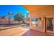 Covered back patio area with tiled flooring offering views of the yard and surrounding homes at 17617 W Corrine Dr, Surprise, AZ 85388