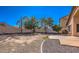Back yard featuring a block wall, desert landscaping, and an extended patio at 17617 W Corrine Dr, Surprise, AZ 85388