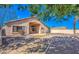View of the home's backyard area with covered patio, landscaping, and gravel at 17617 W Corrine Dr, Surprise, AZ 85388