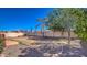 Spacious backyard featuring block fence, gravel, desert landscaping, and some grass at 17617 W Corrine Dr, Surprise, AZ 85388