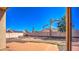 Backyard with a tiled patio and block perimeter fence, landscaping and some grass at 17617 W Corrine Dr, Surprise, AZ 85388