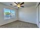 Bright bedroom with a ceiling fan and a large window for ample natural light at 17617 W Corrine Dr, Surprise, AZ 85388