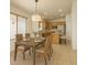 Cozy dining area with views into kitchen, tile flooring, and modern light fixture at 17617 W Corrine Dr, Surprise, AZ 85388