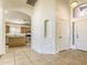 Home foyer and kitchen area featuring modern appliances and tile flooring at 17617 W Corrine Dr, Surprise, AZ 85388