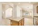 Open concept kitchen features tile flooring and a central island at 17617 W Corrine Dr, Surprise, AZ 85388