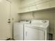 Laundry room featuring a front-loading washing machine and dryer plus overhead shelving at 17617 W Corrine Dr, Surprise, AZ 85388