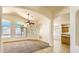 Bright living room with large windows, high ceilings, and decorative arches at 17617 W Corrine Dr, Surprise, AZ 85388