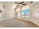 Spacious living room with a ceiling fan and many bright windows offering natural light at 17617 W Corrine Dr, Surprise, AZ 85388