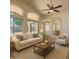 Bright living room with high ceilings, ceiling fan, and sliding glass doors at 17617 W Corrine Dr, Surprise, AZ 85388