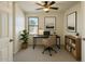 Bright home office with a modern desk, chair, and natural lighting at 17617 W Corrine Dr, Surprise, AZ 85388