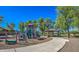 Community playground with slides, climbing structures, and picnic area under shade trees at 17617 W Corrine Dr, Surprise, AZ 85388