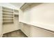 Walk-in closet featuring installed shelving and neutral carpeting at 17617 W Corrine Dr, Surprise, AZ 85388