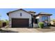 Charming single-story home featuring desert landscaping, a brick driveway, and a two-car garage at 1766 N Channing --, Mesa, AZ 85207