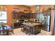 Charming kitchen featuring dark cabinets, granite countertops, and an island with seating at 1766 N Channing --, Mesa, AZ 85207