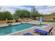 Backyard oasis featuring a sparkling blue pool, with surrounding brick patio, seating, and lush landscaping at 1766 N Channing --, Mesa, AZ 85207