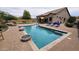 Inviting backyard featuring a sparkling pool, lounge chairs, and outdoor dining area, perfect for entertaining at 1766 N Channing --, Mesa, AZ 85207