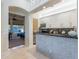 Stylish bar area with a stone-tiled facade, wine rack, and access to the dining room at 19947 N 94Th Way, Scottsdale, AZ 85255