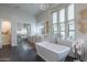 Luxurious bathroom features a soaking tub, modern fixtures, and elegant design at 19947 N 94Th Way, Scottsdale, AZ 85255
