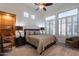 Bright bedroom with large windows, plantation shutters, and a ceiling fan at 19947 N 94Th Way, Scottsdale, AZ 85255
