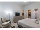 Comfortable bedroom featuring neutral decor and a view into the Primary bathroom and walk-in closet at 19947 N 94Th Way, Scottsdale, AZ 85255
