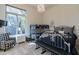 bedroom with a large window, bunk beds, and a modern chandelier at 19947 N 94Th Way, Scottsdale, AZ 85255