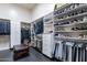 Spacious walk-in closet with custom shelving and storage solutions for clothes and shoes at 19947 N 94Th Way, Scottsdale, AZ 85255