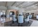Elegant dining room with a glass table, chandelier, and views into the kitchen and entry way at 19947 N 94Th Way, Scottsdale, AZ 85255
