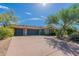 Home featuring an attached three car garage and desert landscaping at 19947 N 94Th Way, Scottsdale, AZ 85255