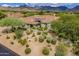 Stunning home exterior boasts desert landscaping and mountain views, creating a serene and picturesque setting at 19947 N 94Th Way, Scottsdale, AZ 85255