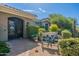 Front yard with a decorative garden bench, desert landscaping, and a security gate at 19947 N 94Th Way, Scottsdale, AZ 85255