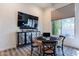 Entertaining game room featuring a poker table, large window with shade, and a stylish wall-mounted TV at 19947 N 94Th Way, Scottsdale, AZ 85255