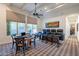 Game room with a poker table, theater seating, large windows, and a ceiling fan for added comfort at 19947 N 94Th Way, Scottsdale, AZ 85255