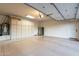 Spacious garage with epoxy floors, built-in cabinets, and stainless steel refrigerator at 19947 N 94Th Way, Scottsdale, AZ 85255