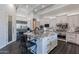 A kitchen island with marble countertops and white cabinets and stainless steel refrigerator at 19947 N 94Th Way, Scottsdale, AZ 85255