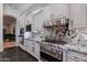 Spacious kitchen with marble countertops, stainless steel appliances and white cabinets at 19947 N 94Th Way, Scottsdale, AZ 85255