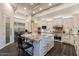 Modern kitchen with a large island, stainless steel appliances, and a view into the adjacent living spaces at 19947 N 94Th Way, Scottsdale, AZ 85255
