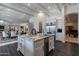 A kitchen island with marble countertops and a stainless steel refrigerator and sink at 19947 N 94Th Way, Scottsdale, AZ 85255