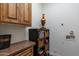Wood cabinets and shelving, as well as a playful chef figurine, adorn this laundry room at 19947 N 94Th Way, Scottsdale, AZ 85255