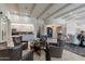 Open-concept living space with high ceilings, exposed beams, modern furniture, and views into the kitchen at 19947 N 94Th Way, Scottsdale, AZ 85255