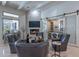 Cozy living room with a fireplace, mounted TV, comfortable seating, and a wine storage area at 19947 N 94Th Way, Scottsdale, AZ 85255