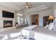 Inviting main bedroom featuring a stone fireplace and plenty of natural light at 19947 N 94Th Way, Scottsdale, AZ 85255