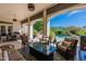 Covered outdoor seating area with a gas fire pit and a view of the backyard pool at 19947 N 94Th Way, Scottsdale, AZ 85255