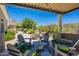 Charming outdoor seating area with comfortable chairs overlooking the lush landscaping and pool at 19947 N 94Th Way, Scottsdale, AZ 85255