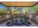 Inviting covered patio with comfortable seating, string lights, and stylish decor at 19947 N 94Th Way, Scottsdale, AZ 85255