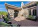 A comfortable patio space with brick pavers, water feature and potted plants for a relaxing setting at 19947 N 94Th Way, Scottsdale, AZ 85255