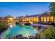 An inviting backyard pool, illuminated at twilight, creates a tranquil ambiance for evening relaxation and entertainment at 19947 N 94Th Way, Scottsdale, AZ 85255